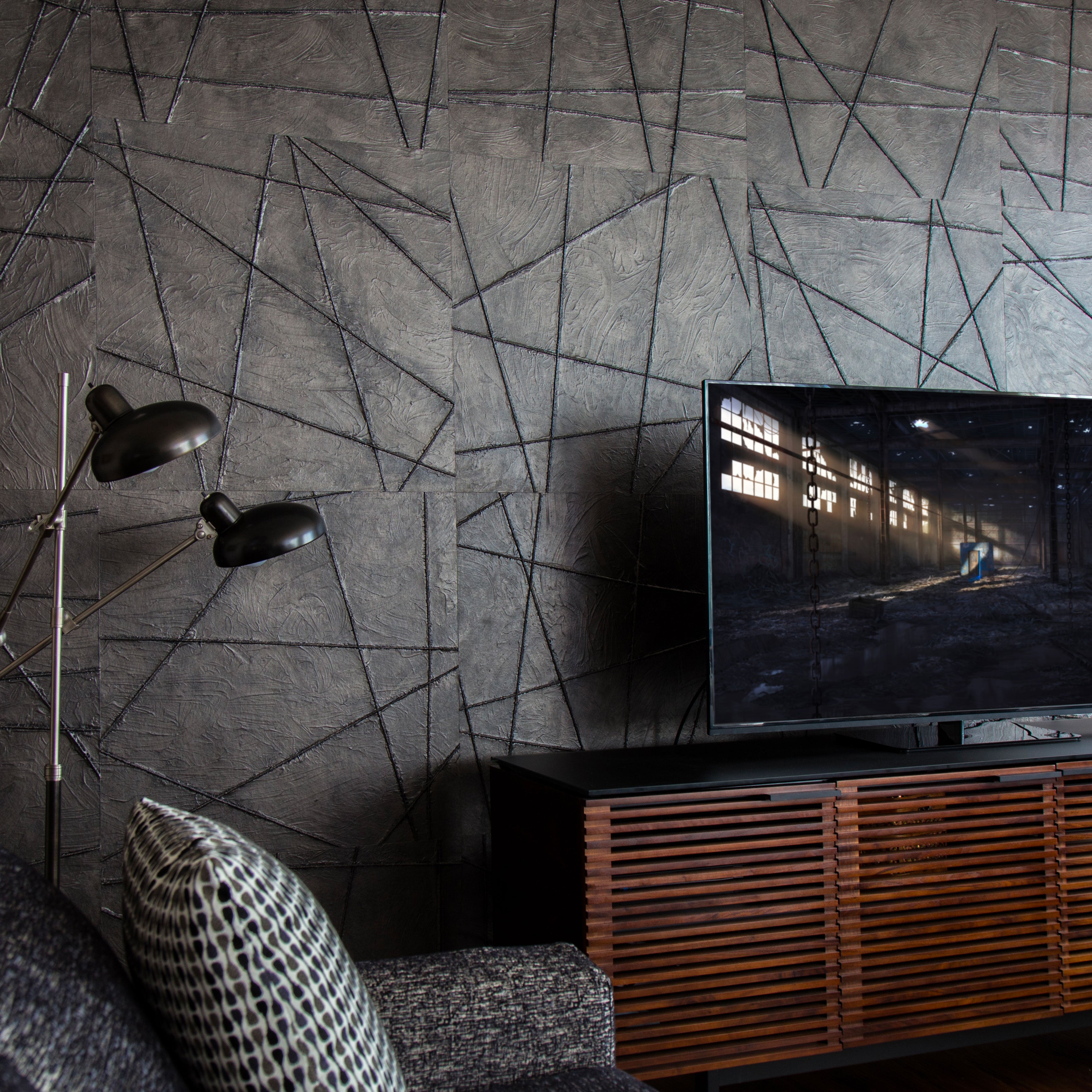 A section of textured wallpaper with a geometric broken lines pattern in a room with modern decor.